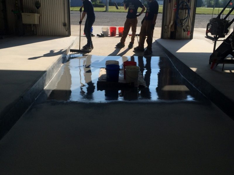 Dark gray polished concrete floor with flintshot broadcast