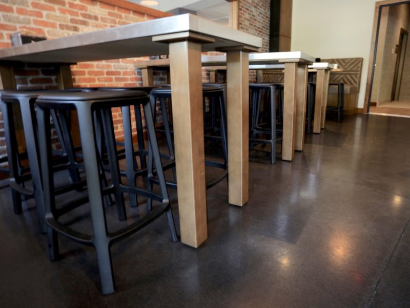 Tucked in stools with a brick wall