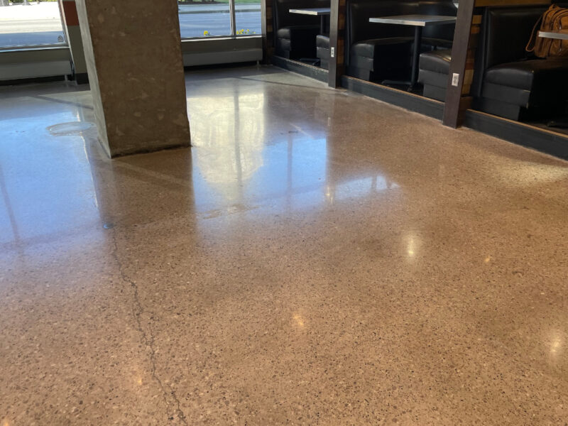 Polished concrete floor in an empty room with support beam